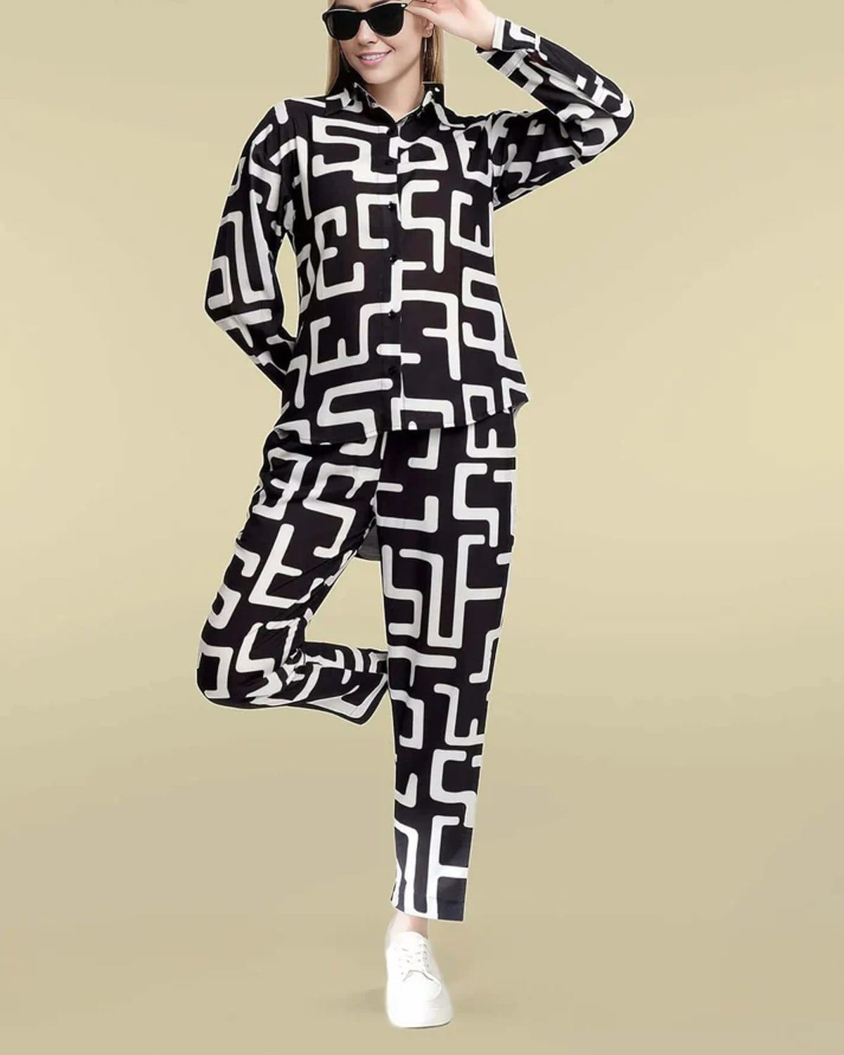 Black and ivory geometric-print silk co-ord with button-up shirt and straight-leg trousers.
