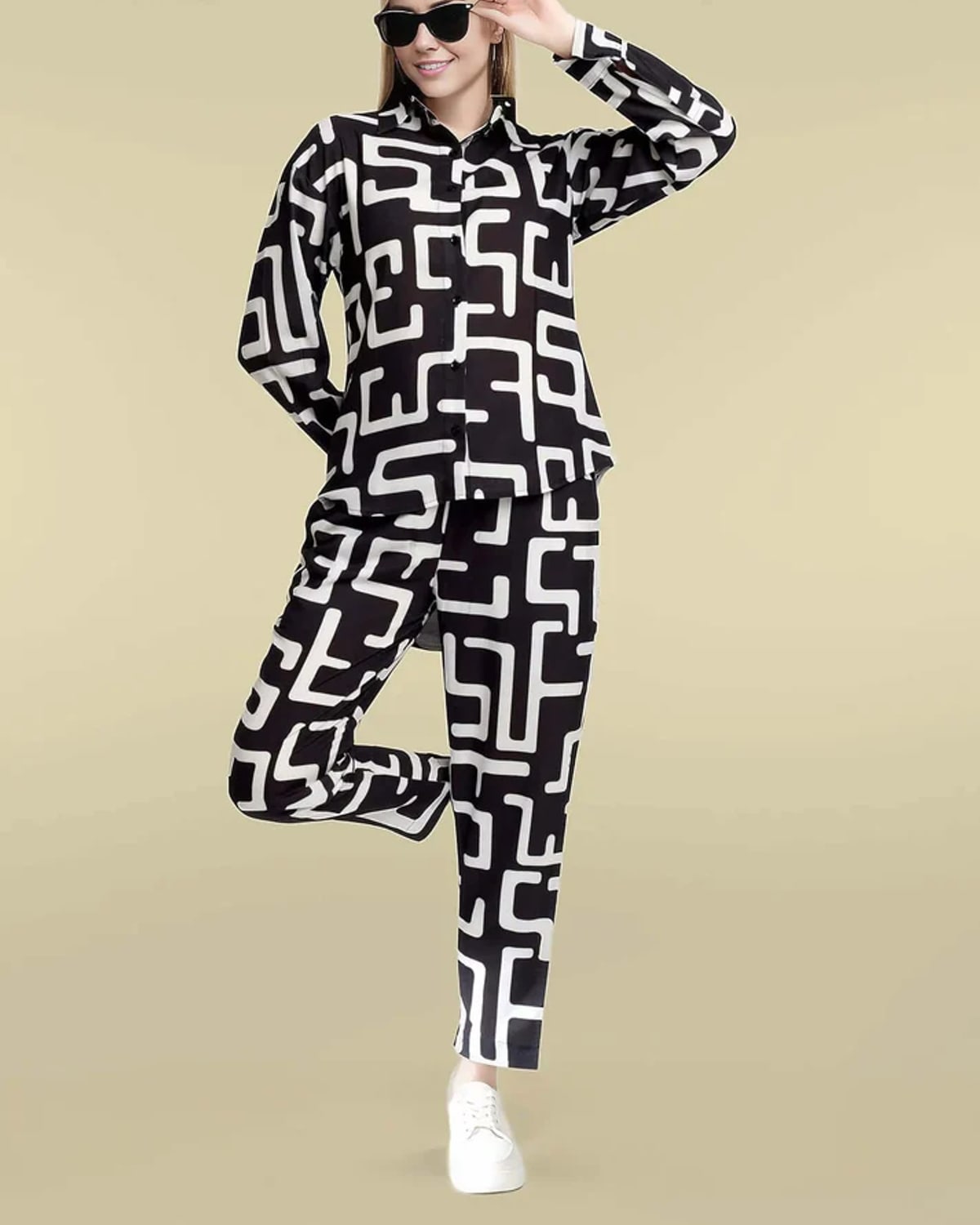 Black and ivory geometric-print silk co-ord with button-up shirt and straight-leg trousers.